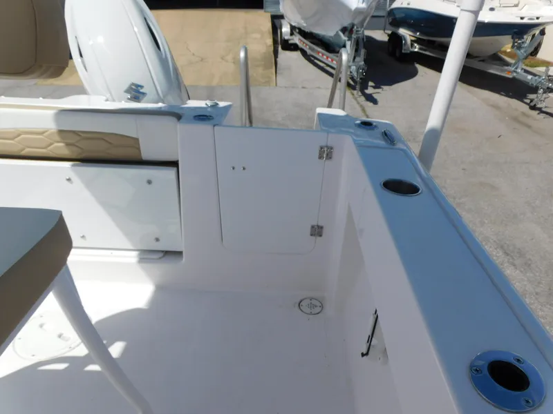 Slide: The Image of 2024 Aquasport 2200 Center Console boat interior, featuring seating and storage compartments. - 35