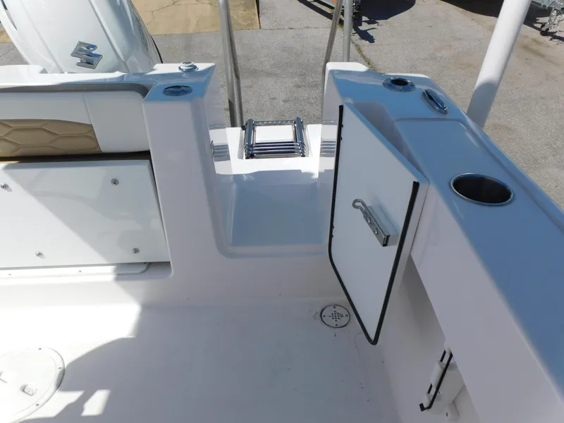 Slide: The Image of 2024 Aquasport 2200 Center Console boat interior with storage compartments and ladder. - 36