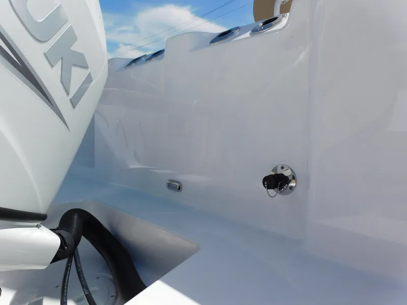 Slide: The Image of 2024 Aquasport 2200 Center Console boat with Suzuki engine, close-up view. - 9