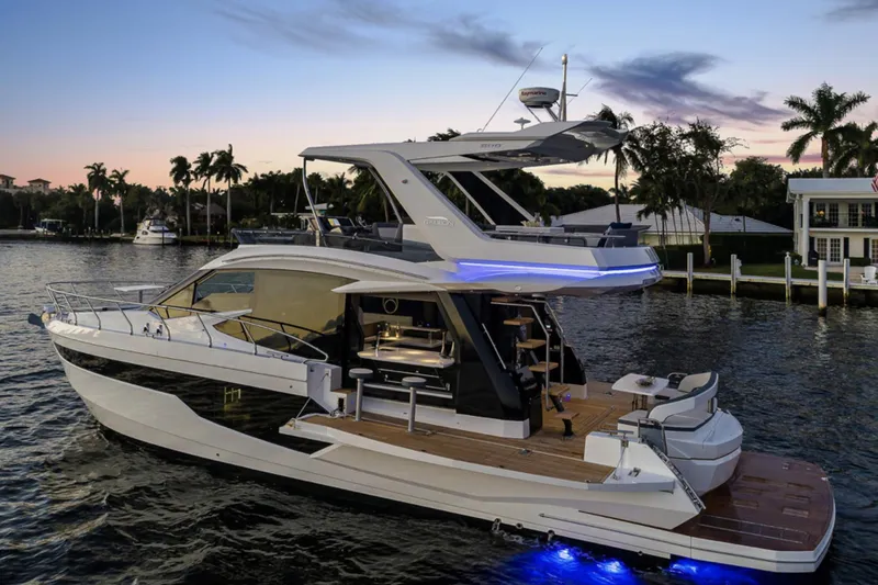 The Image of 2025 Galeon 500 Fly luxury yacht at sunset on a calm waterway. - 0