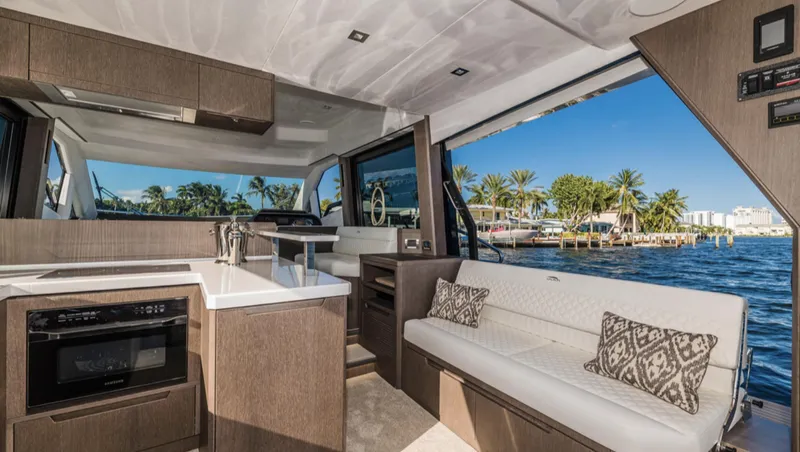 Slide: The Image of Interior of 2025 Galeon 500 Fly yacht with modern kitchen and seating area. - 9