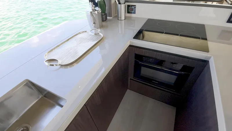 Slide: The Image of Modern kitchen on the 2024 Galeon 560 Fly yacht with sleek appliances. - 14