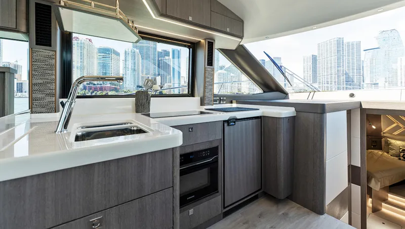 Slide: The Image of Modern kitchen interior of 2025 Galeon 440 Fly yacht with city skyline view. - 11