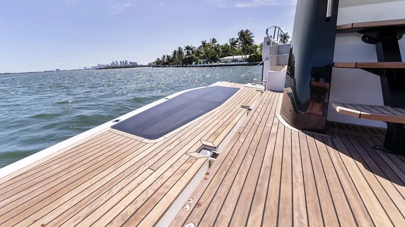 Slide: The Image of Galeon 440 Fly 2025 yacht deck with ocean view and wooden flooring. - 4