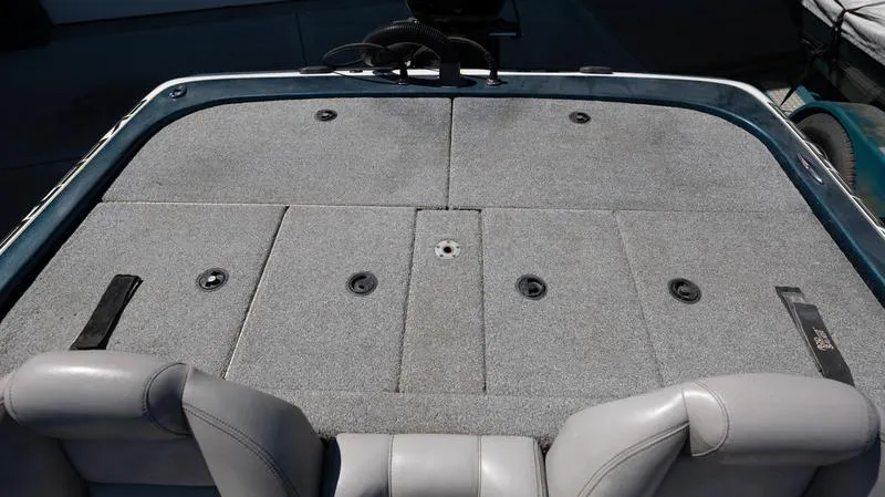 Slide: The Image of 2001 Skeeter ZX200 boat deck with gray carpet and storage compartments. - 11