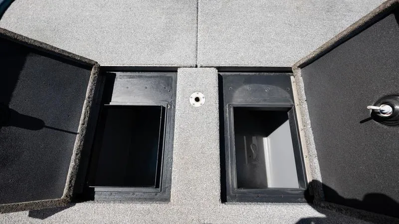 Slide: The Image of 2001 Skeeter ZX200 boat storage compartments with open lids. - 6