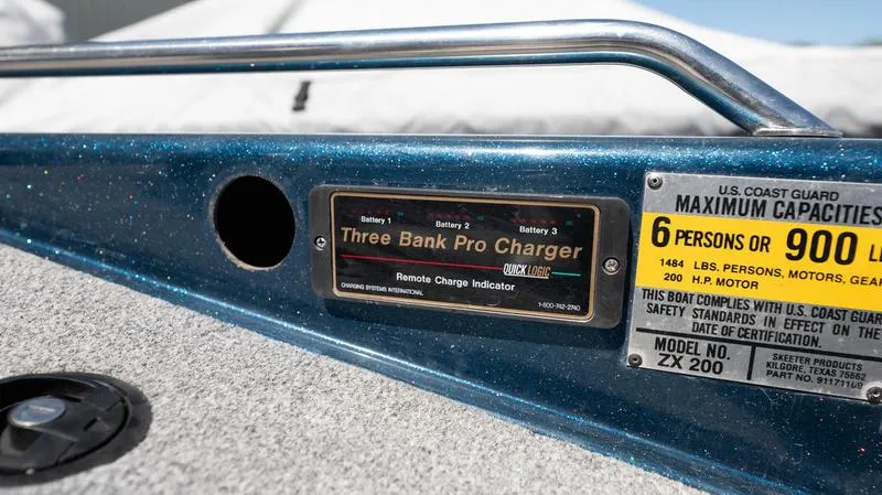 Slide: The Image of 2001 Skeeter ZX200 boat dashboard with Three Bank Pro Charger and capacity label. - 7
