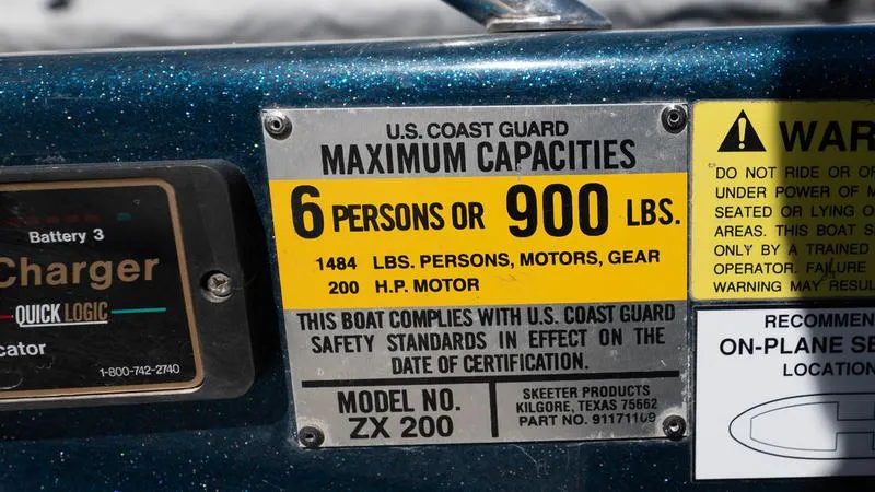 Slide: The Image of 2001 Skeeter ZX200 boat capacity label, 6 persons or 900 lbs, 200 HP motor. - 8