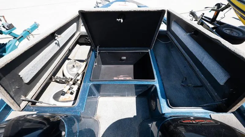 Slide: The Image of 2001 Skeeter ZX200 boat interior with open storage compartments and fishing gear. - 9
