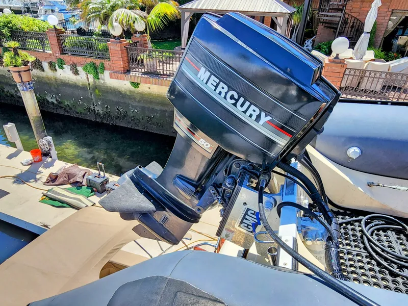 Slide: The Image of Mercury outboard motor on a 1987 Hi-Star Yacht Fisher 55 docked near a canal. - 20