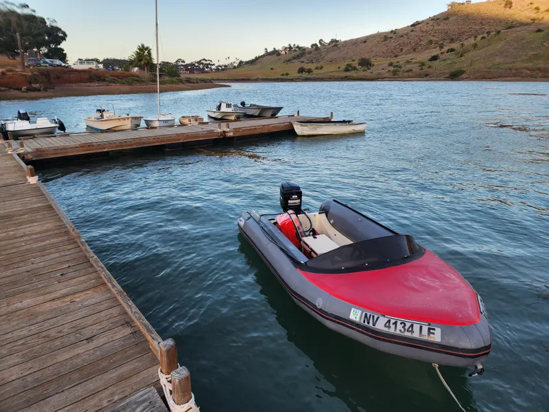 Slide: The Image of Small motorboat docked at a wooden pier on a calm lake. - 21