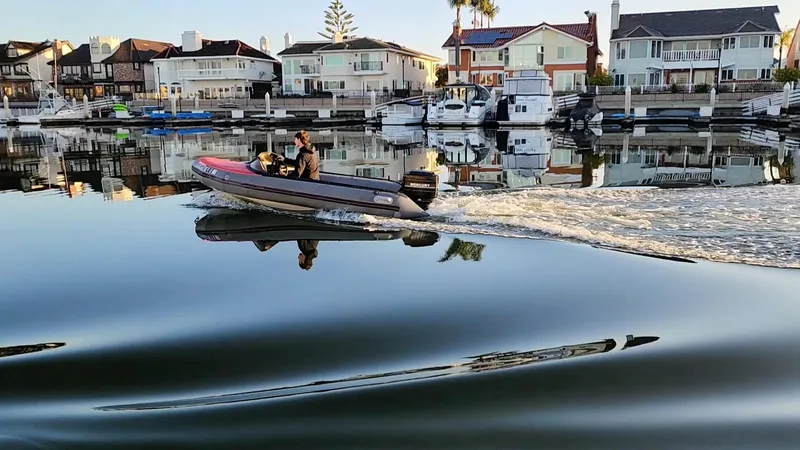 Slide: The Image of A 1987 Hi-Star Yacht Fisher 55 cruising in a calm marina with waterfront homes. - 22