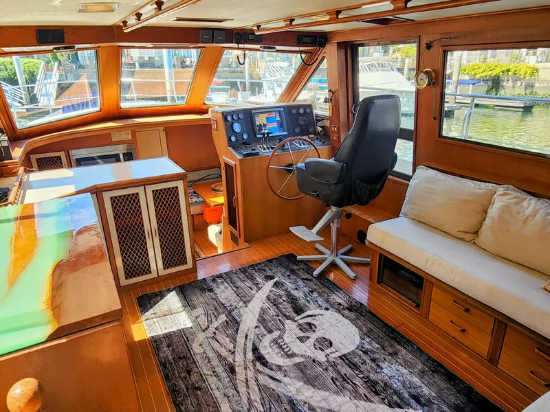 Slide: The Image of Interior of 1987 Hi-Star Yacht Fisher 55 with helm, seating, and nautical decor. - 26