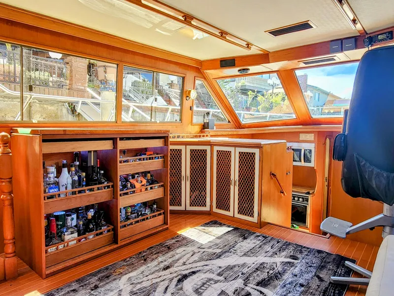 Slide: The Image of Interior of 1987 Hi-Star Yacht Fisher 55 with wooden cabinetry and panoramic windows. - 28