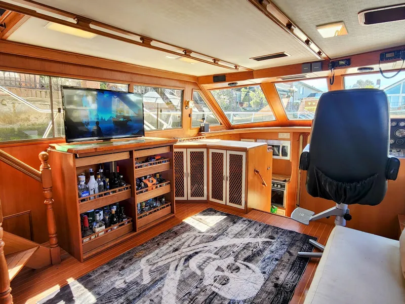 Slide: The Image of Interior of 1987 Hi-Star Yacht Fisher 55 with bar, TV, and captain's chair. - 29