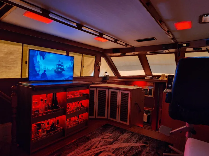 Slide: The Image of 1987 Hi-Star Yacht Fisher 55 interior with TV, bar, and ambient lighting. - 37