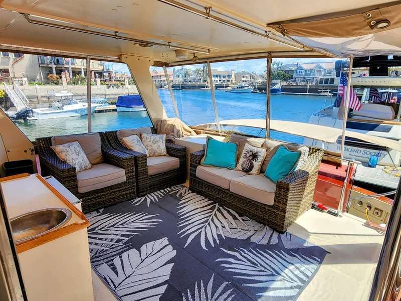 Slide: The Image of Spacious interior of 1987 Hi-Star Yacht Fisher 55 with wicker furniture and waterfront view. - 4