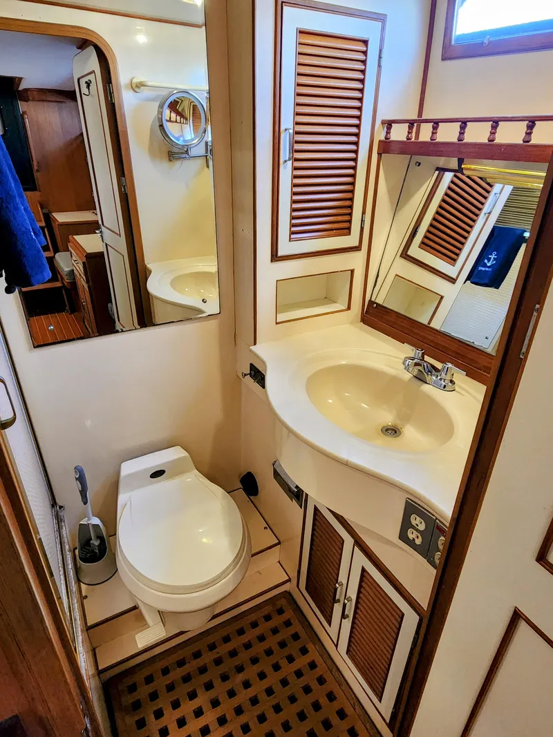 Slide: The Image of 1987 Hi-Star Yacht Fisher 55 bathroom with sink, toilet, and wooden cabinetry. - 41