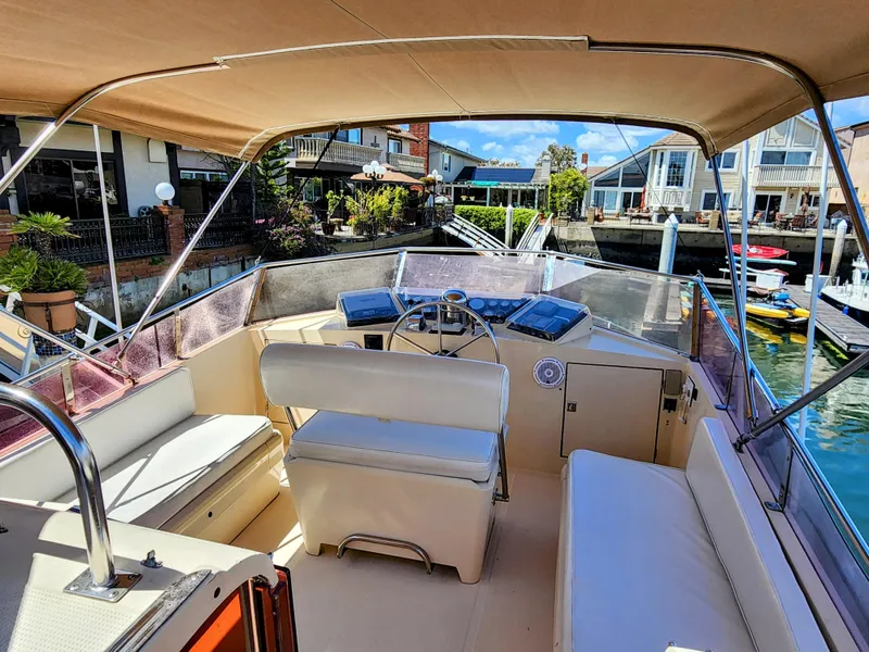 Slide: The Image of 1987 Hi-Star Yacht Fisher 55 flybridge with seating and helm station. - 6
