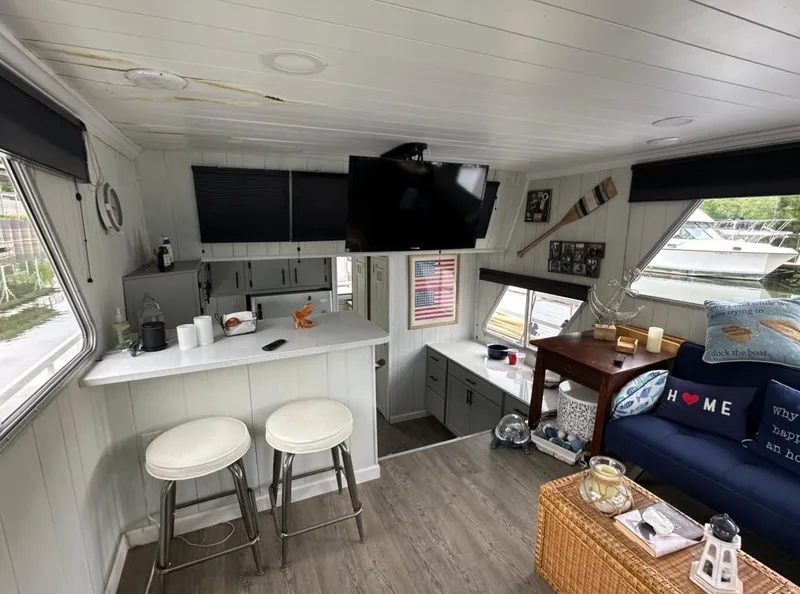 Slide: The Image of Cozy interior of a 1990 Gibson 50 Classic houseboat with modern decor and seating area. - 10