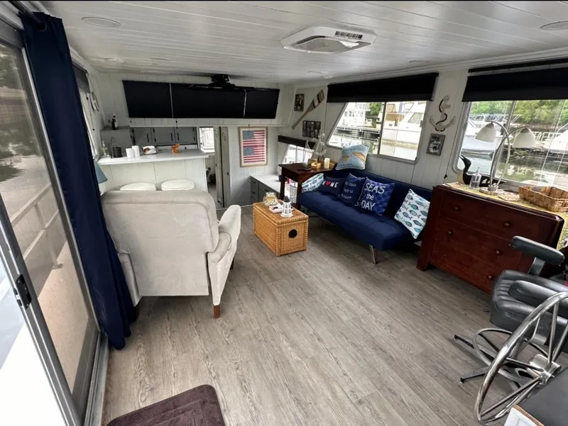Slide: The Image of Cozy 1990 Gibson 50 Classic houseboat interior with modern furnishings and large windows. - 12