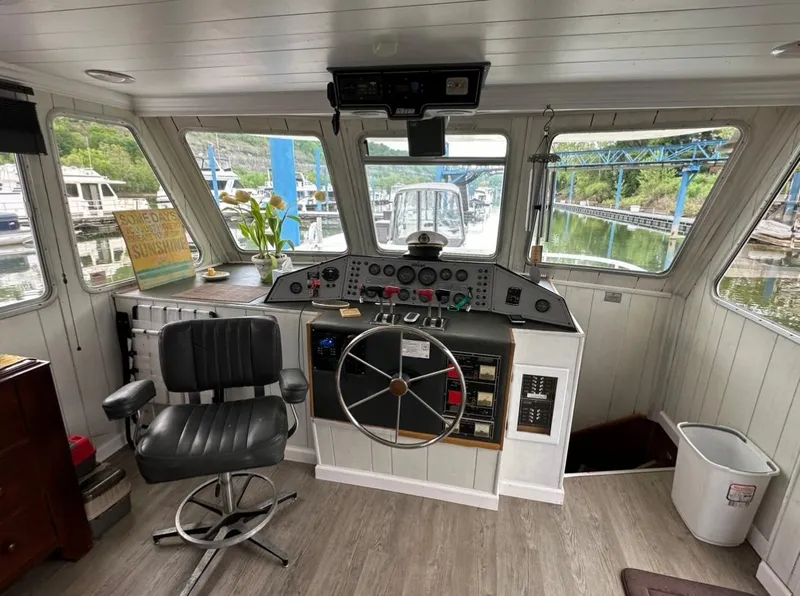 Slide: The Image of Interior of a 1990 Gibson 50 Classic boat with steering wheel and control panel. - 13