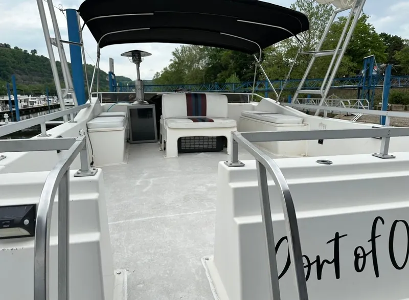 Slide: The Image of Upper deck of a 1990 Gibson 50 Classic boat with seating and canopy. - 6