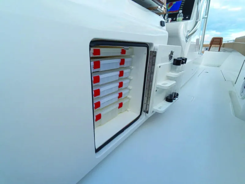 Slide: The Image of 2025 Valhalla Boatworks V-37 storage compartment with organized tackle trays. - 10