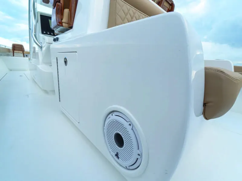 Slide: The Image of 2025 Valhalla Boatworks V-37, close-up of white deck with speaker and storage compartment. - 12