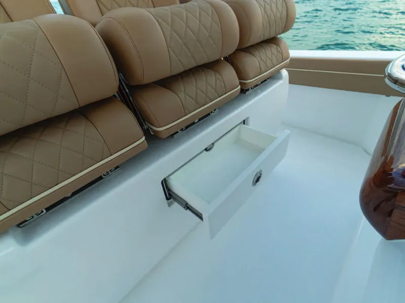 Slide: The Image of 2025 Valhalla Boatworks V-37 seating with storage drawer open, showcasing luxury and functionality. - 23