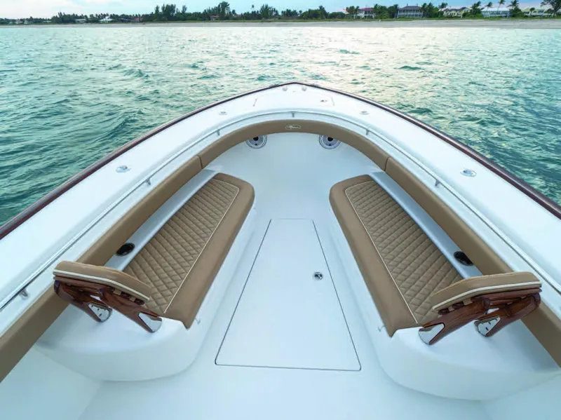 Slide: The Image of Valhalla Boatworks V-37 2025 model bow seating area on calm water. - 25
