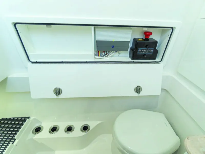Slide: The Image of Valhalla Boatworks V-37 2025 model bathroom with toilet and control panel. - 28