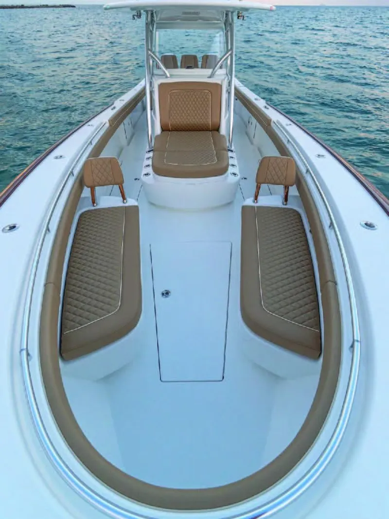 Slide: The Image of 2025 Valhalla Boatworks V-37 with tan seating and white deck on the water. - 35