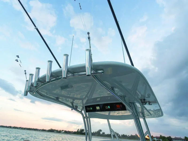 Slide: The Image of 2025 Valhalla Boatworks V-37 fishing rods and T-top against a scenic sky. - 39