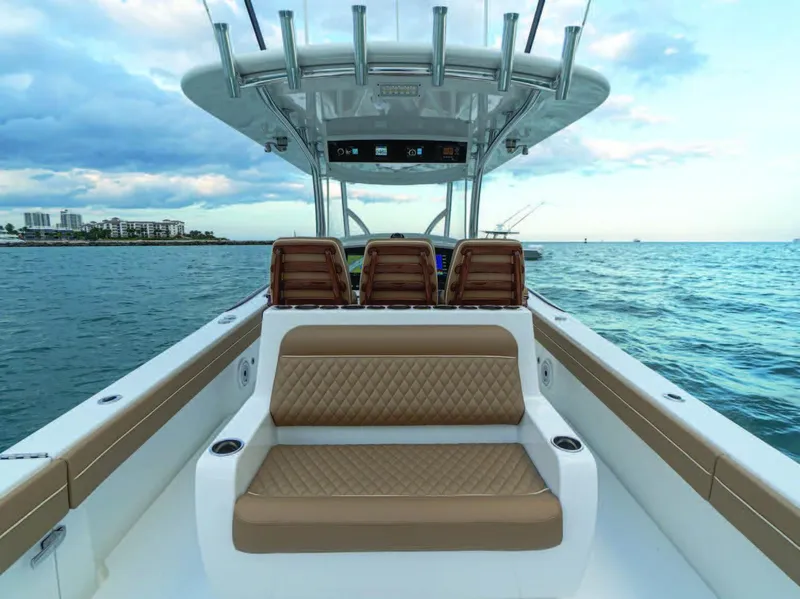 Slide: The Image of 2025 Valhalla Boatworks V-37 interior with seating, ocean view, and modern helm station. - 8