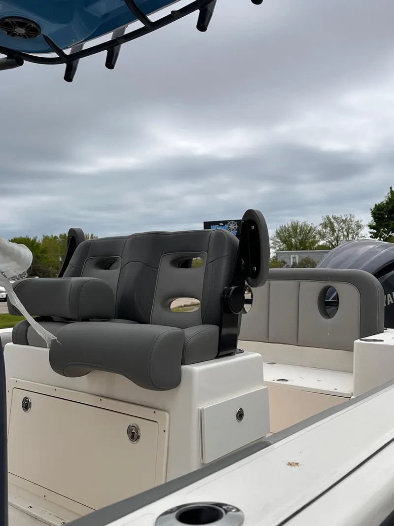 Slide: The Image of 2024 Sea Born LX24 Center Console boat with cushioned seating and storage compartments. - 4