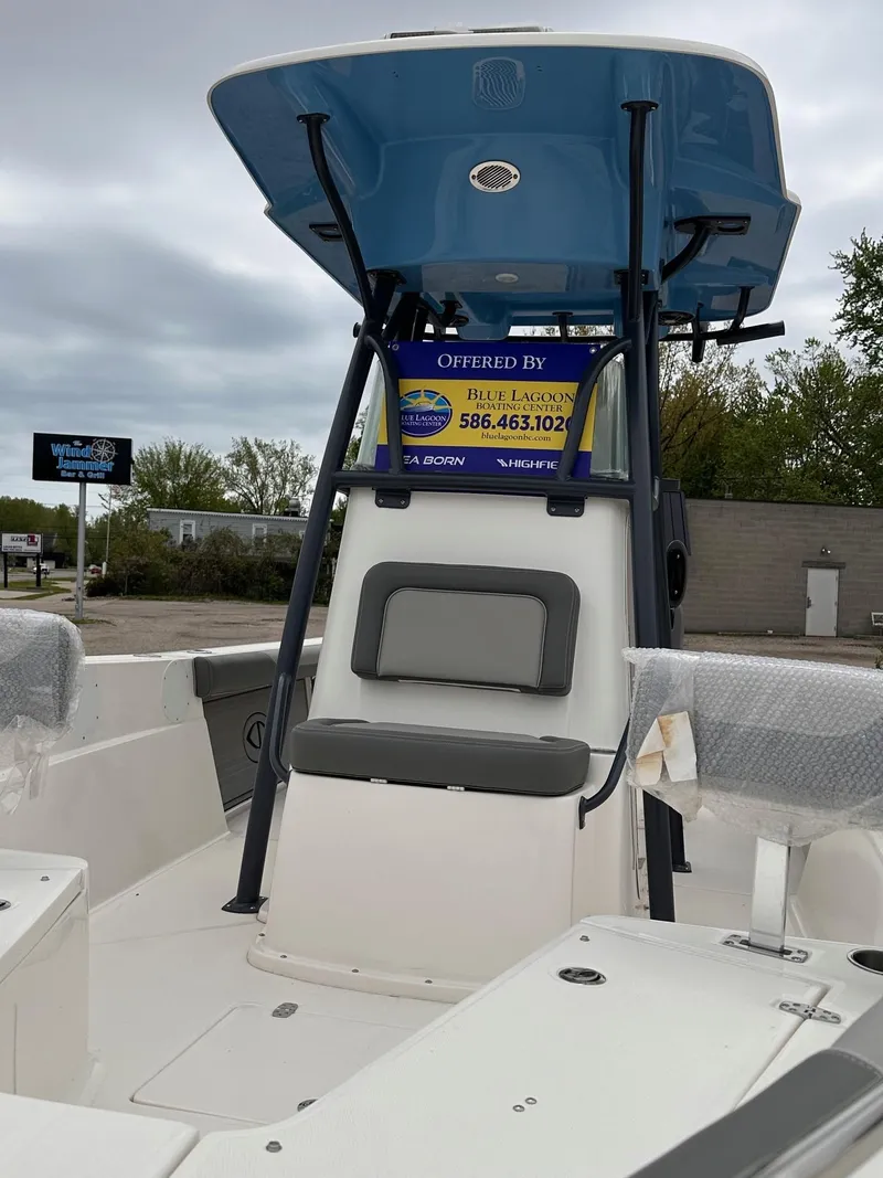 Slide: The Image of 2024 Sea Born LX24 Center Console boat with blue T-top and seating. - 6