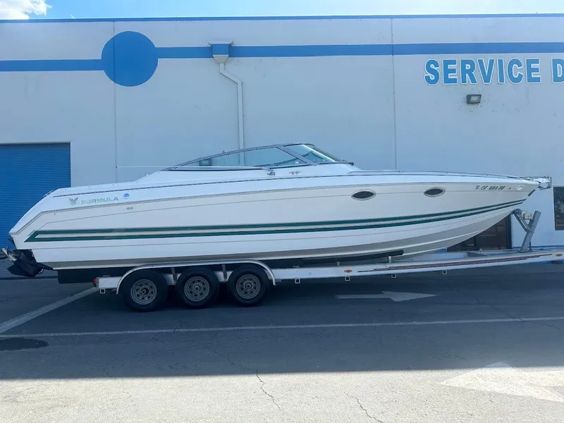 Slide: The Image of 1999 Formula 330 SS boat on a trailer outside a service department. - 0