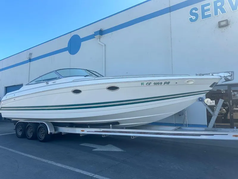 Slide: The Image of 1999 Formula 330 SS boat on a trailer outside a service center. - 1