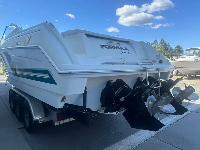 Slide: The Image of 1999 Formula 330 SS boat on trailer, rear view with dual propellers. - 10