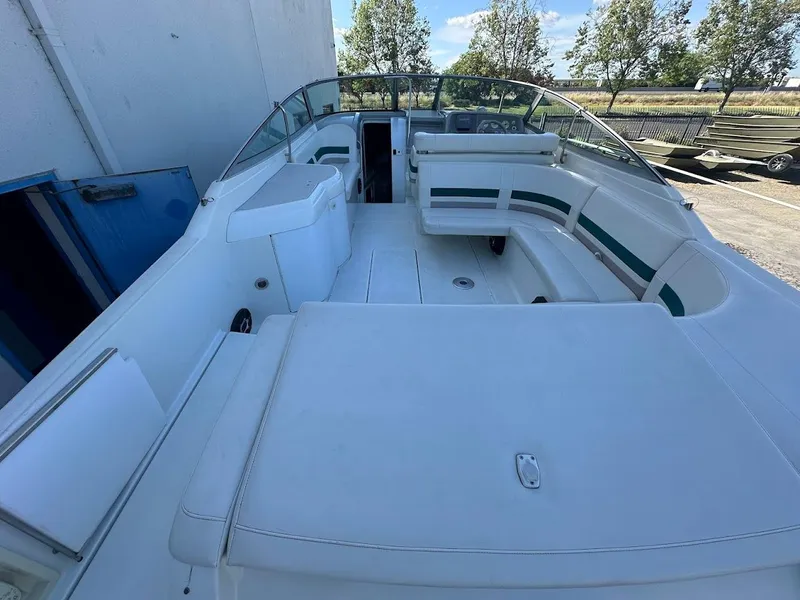 Slide: The Image of 1999 Formula 330 SS boat interior with white seating and open deck. - 12