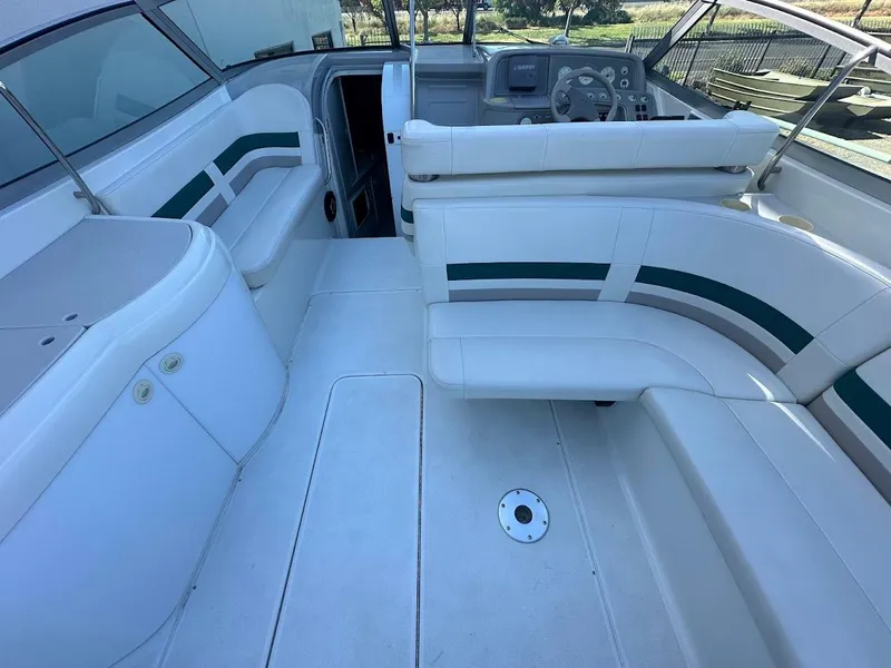 Slide: The Image of 1999 Formula 330 SS boat interior with white and green seating. - 15