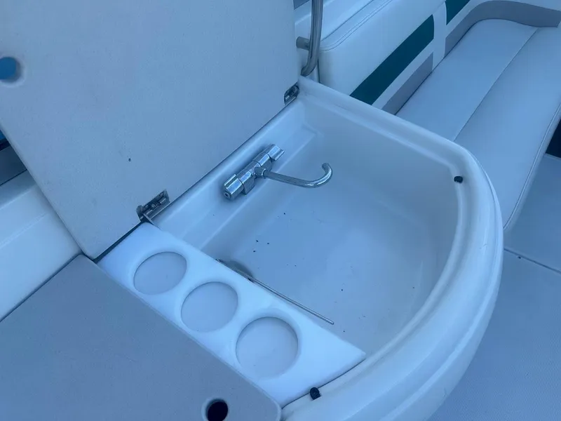Slide: The Image of Open storage compartment on a 1999 Formula 330 SS boat with cup holders. - 17