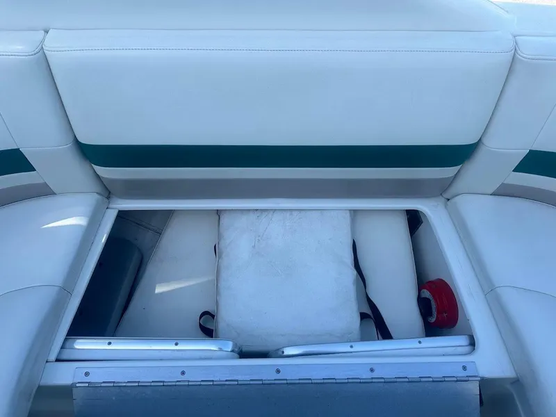 Slide: The Image of 1999 Formula 330 SS boat storage compartment with white and green seating. - 19
