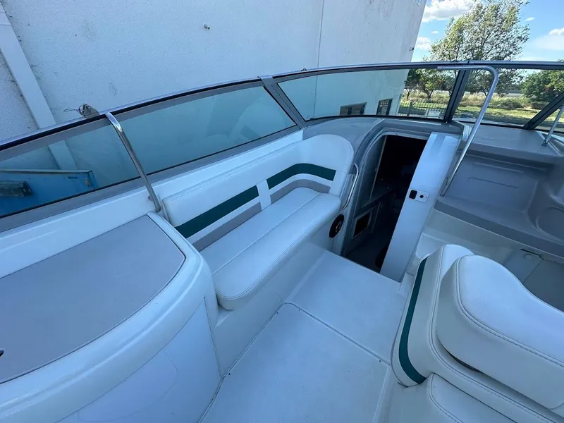 Slide: The Image of 1999 Formula 330 SS boat interior with white and green seating. - 22