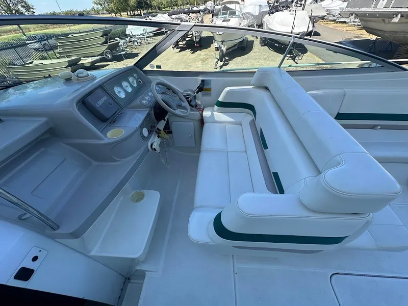 Slide: The Image of 1999 Formula 330 SS boat interior with white seating and dashboard. - 23