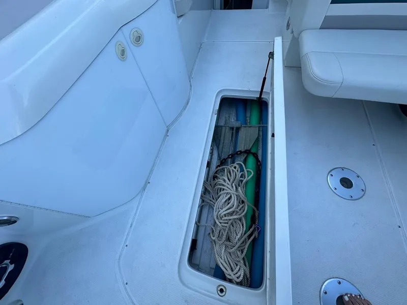 Slide: The Image of 1999 Formula 330 SS boat deck with open storage compartment containing ropes. - 29