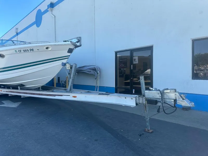 Slide: The Image of 1999 Formula 330 SS boat on a trailer outside a building. - 3