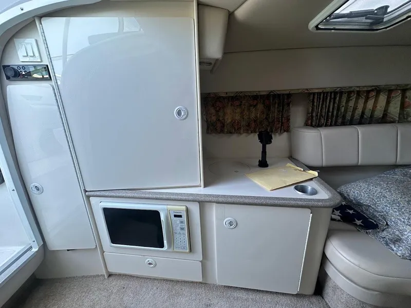 Slide: The Image of 1999 Formula 330 SS cabin interior with microwave and seating area. - 34