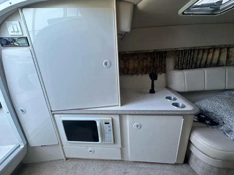 Slide: The Image of 1999 Formula 330 SS cabin interior with microwave and storage cabinets. - 35